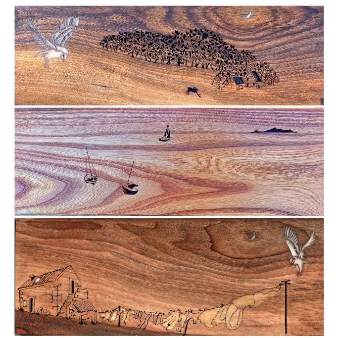 Three wooden panels featuring detailed engravings of nature, boats, and a coastal scene.