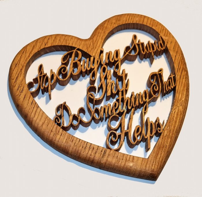Wooden plaque with intricate scrolled text