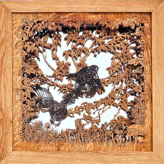 Intricately carved wooden frame featuring birds and foliage design.