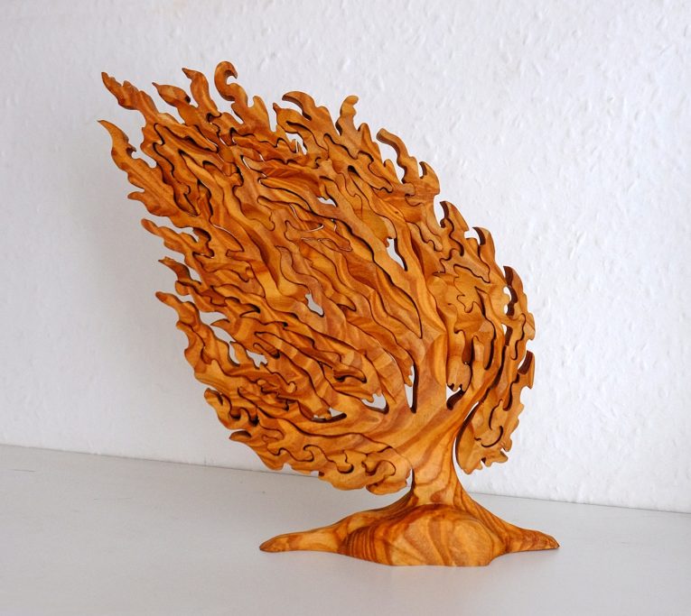 Carved wooden sculpture of a stylised tree. A puzzle that stands free when constructed