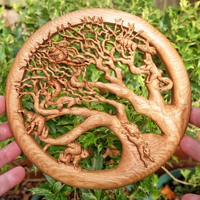 Intricate wood carving of squirrels in a tree